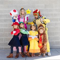 a group of people standing next to each other wearing costumes and posing for the camera