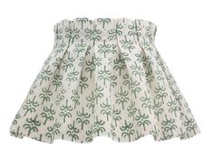 a skirt with green and white designs on the bottom, in front of a white background