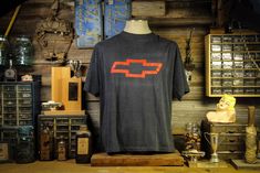 "* Vintage Chevrolet T-Shirt  * Bow Tie graphic on front (Heartbeat logo on back) * 50/50 size XXL (It fits more like an XL)  * Pit to pit : 22\" Collar to bottom : 27.7\" * Screen printing cracking a fading but consistent with age" Heartbeat Logo, Vintage Chevrolet, Anaheim, 50 50, In A Heartbeat, Country Music, Bow Tie, Chevy, Screen Printing