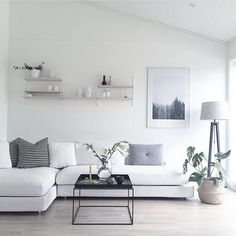 a living room with white walls and furniture