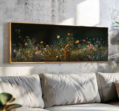 a painting hanging on the wall above a couch