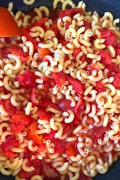 the pasta dish is prepared and ready to be eaten with carrots on the side