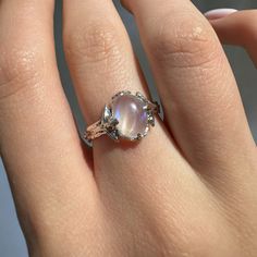 a woman's hand with a ring that has a large stone in the middle