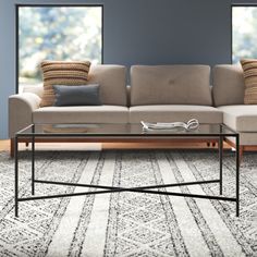 a living room scene with focus on the couch and coffee table in the foreground