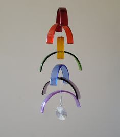 a multicolored wind chime hanging from a ceiling