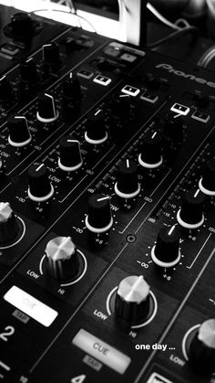 an electronic mixing console with buttons and knobs on it's side, in black and white