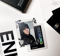 some black and white business cards on top of a table with other items in the background