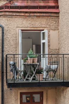 an apartment balcony with potted plants on the balconies