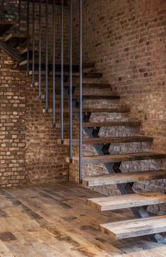 an old brick building with wooden floors and stairs