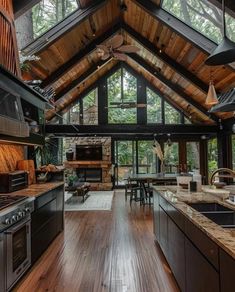 a large kitchen with wooden floors and vaulted ceiling