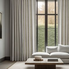 a white couch sitting in front of a window