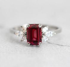 The Janine ring with gorgeous umba garnet and marquise white diamonds on the side, is truly a ring that will not go unnoticed. With it’s jaw dropping beautiful red color it is mesmerising and any lady would be happy to have this as her engagement ring. Details Center stone Gemstone: Natural Umba valley garnet Color: re Marquise Red Diamond Ring, Luxury Marquise Red Ruby Ring, Luxury Red Marquise Ruby Ring, Exquisite Red Cubic Zirconia Rings, Red Cluster Ring With Brilliant Cut For Wedding, Red Brilliant Cut Cluster Ring For Wedding, Red Wedding Cluster Ring With Brilliant Cut, Luxury Marquise Cut Red Ruby Ring, Luxury Red Marquise Cut Ruby Ring