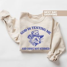 Hi! Welcome to the TeeScape! It's great to see you here! God Is Testing Me Funny Unisex Sweatshirt, Possum Shirt, Meme Shirt, Raccoon Meme Shirt, Men Shirt, Trash Panda Shirt, Vintage Drawing Shirt Our shirts are clean, high quality and soft. It is prepared quickly by our store! Enjoy your shopping! It is a pleasure for us to help you with your questions and you can reach us at any time. F I T ∙ S I Z I N G -->Women's sizes are narrower than the waist -->Sleeves are rolled up in some product pic God Is Testing Me, Cricut T Shirt Ideas, Funny Shirt Designs, Possum Shirt, Trash Panda Shirt, Raccoon Meme, Funny Clothes, Panda Shirt