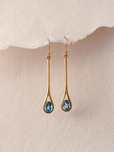 S W I S S ∙ B L U E ∙ T O P A Z ∙ E A R R I N G S These earrings are crafted with 24k gold vermeil over 925 sterling silver. Each earring features two exquisite oval-cut Swiss blue topaz gemstones, beautifully set in a graceful teardrop design that captures the light with every movement. The vibrant blue hues of the topaz create a striking contrast against the warm gold, making these earrings perfect for both casual and formal occasions.  This earring is also available in Peridot, Garnet, Amethyst, Citrine and Iolite Gemstones. Please write to us for customisations.  * Material: 24K Gold Vermeil on 925 Sterling Silver - Hypo-Allergenic and Nickel Free * Finish: 24K Gold Vermeil on 925 Sterling Silver | Also available in solid 925 Sterling Silver * Featuring 2 Pieces of 7*9 MM Oval Swiss Bl Handcrafted Silver Jewelry, Blue Topaz Earrings, Natural Stone Jewelry, Topaz Earrings, Swiss Blue Topaz, Topaz Gemstone, Elegant Jewelry, Solid 925 Sterling Silver, Stone Jewelry