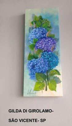 a painting on the wall with blue flowers and green leaves in front of it, that says gilda di girollamo sao vicentee - sp