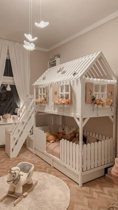 a white bunk bed sitting next to a window in a child's playroom