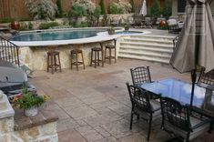 an outdoor patio with tables, chairs and umbrellas next to a pool in the backyard