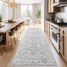 a large rug in the middle of a kitchen with wooden cabinets and counter tops on both sides