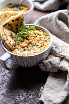 a white bowl filled with food on top of a table