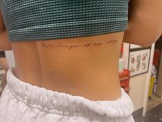 a woman's lower back with the words i am enough to say love written on it