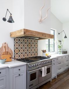 a kitchen with gray cabinets and an oven