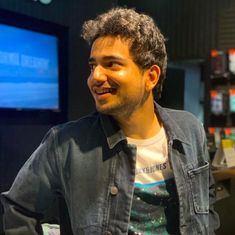 a man standing in front of a computer monitor