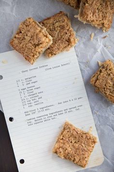 several pieces of food sitting on top of a piece of paper next to each other