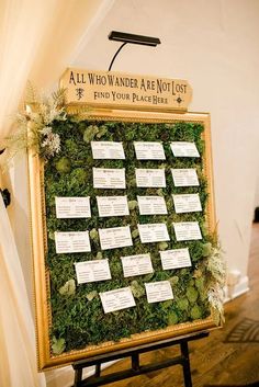 a moss covered board with notes attached to it