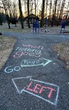 chalk writing on the ground at a park