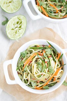 a white bowl filled with noodles and vegetables