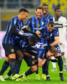 a group of men playing soccer on a field