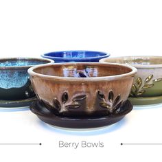 four bowls with different designs on them sitting side by side in the same pattern and color