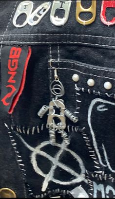 the back pocket of a pair of black jeans with red, white and blue patches on them