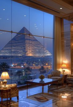 the interior of a hotel room with a view of the pyramid