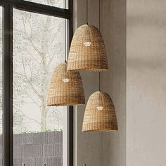 three lamps hanging from the ceiling over a dining room table