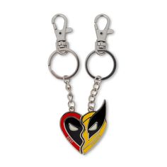 two heart shaped key chains with an arrow