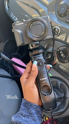 a person holding a camera in their left hand and recording the inside of a car