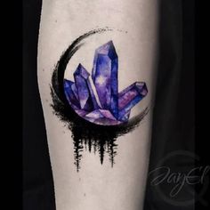 an artistic tattoo with purple crystals on the arm