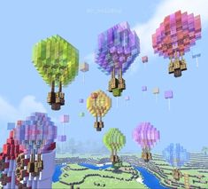 several colorful hot air balloons floating in the sky over a river and land with trees