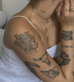 a woman with many tattoos on her arm