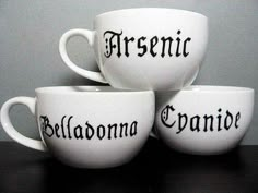 three white coffee cups sitting on top of a black table next to each other with the words,