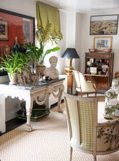 a living room filled with lots of furniture and plants on top of a white table