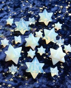 small white stars on a blue background with gold sparkles and glitter flecks