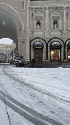 a large building that has snow on the ground