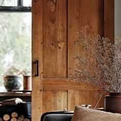 a living room filled with furniture and wooden walls