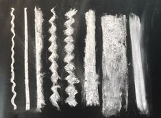 chalk drawings on a blackboard showing different types of lines and curves in white paint