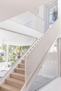 there is a staircase leading up to the second floor in this modern home with white walls and wood floors