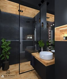 a modern bathroom with black walls and wood flooring on the wall, along with a large white bowl sink