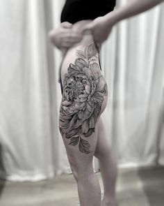 a person with a flower tattoo on their leg