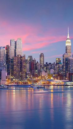 the city skyline is lit up at night